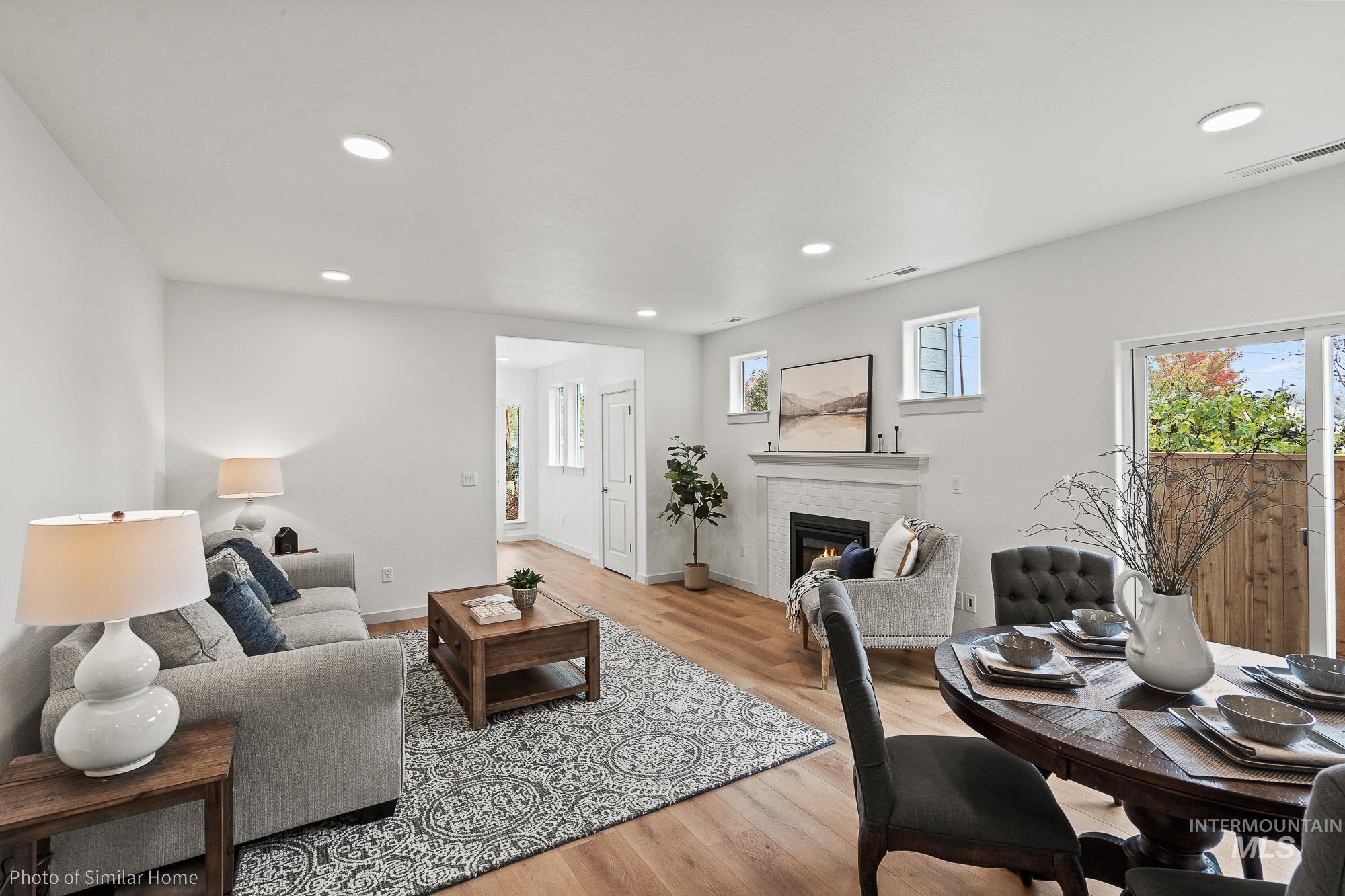 Living area with a fireplace, recessed lighting, and light wood finished floors