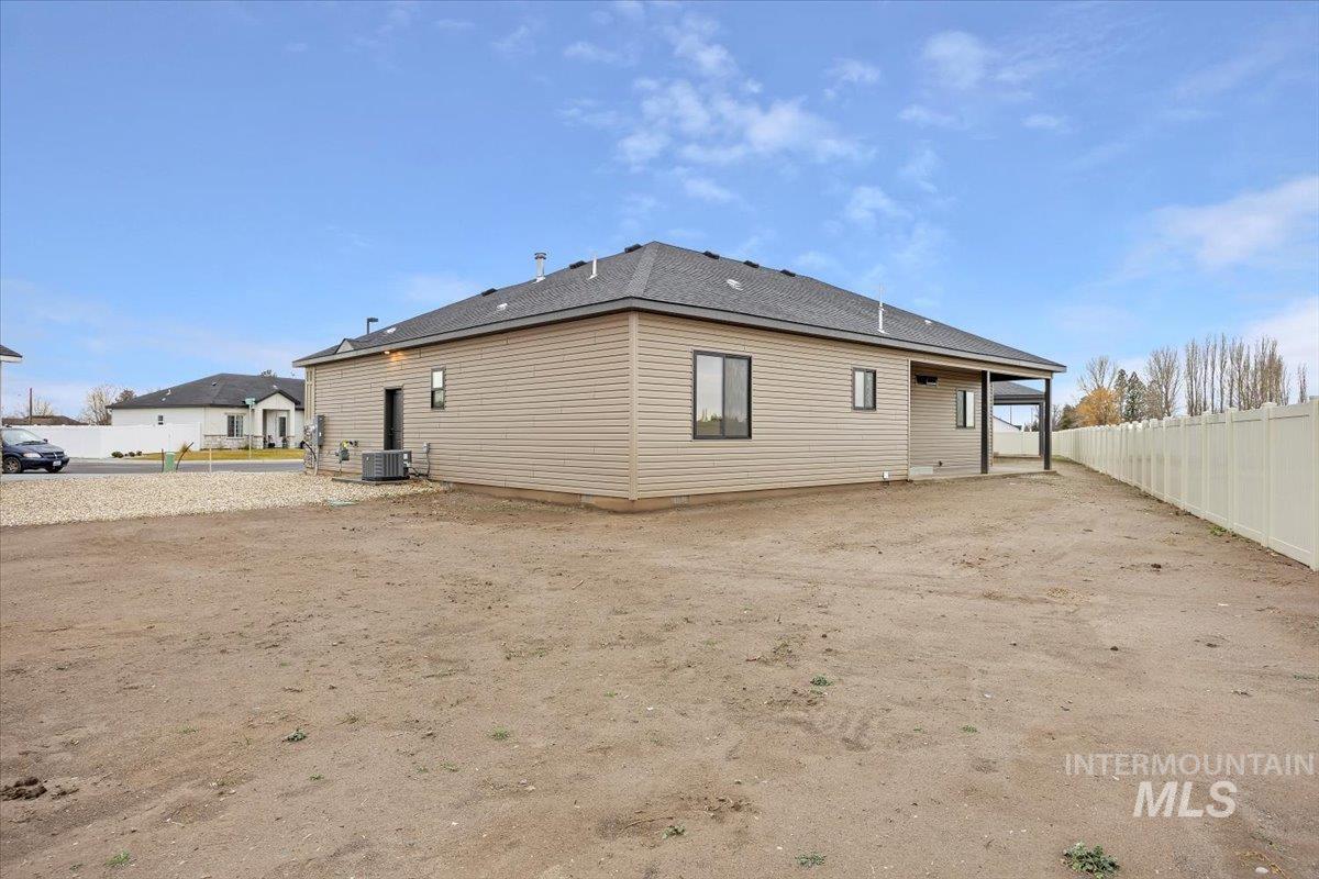 Back of property featuring a patio area and roof with shingles
