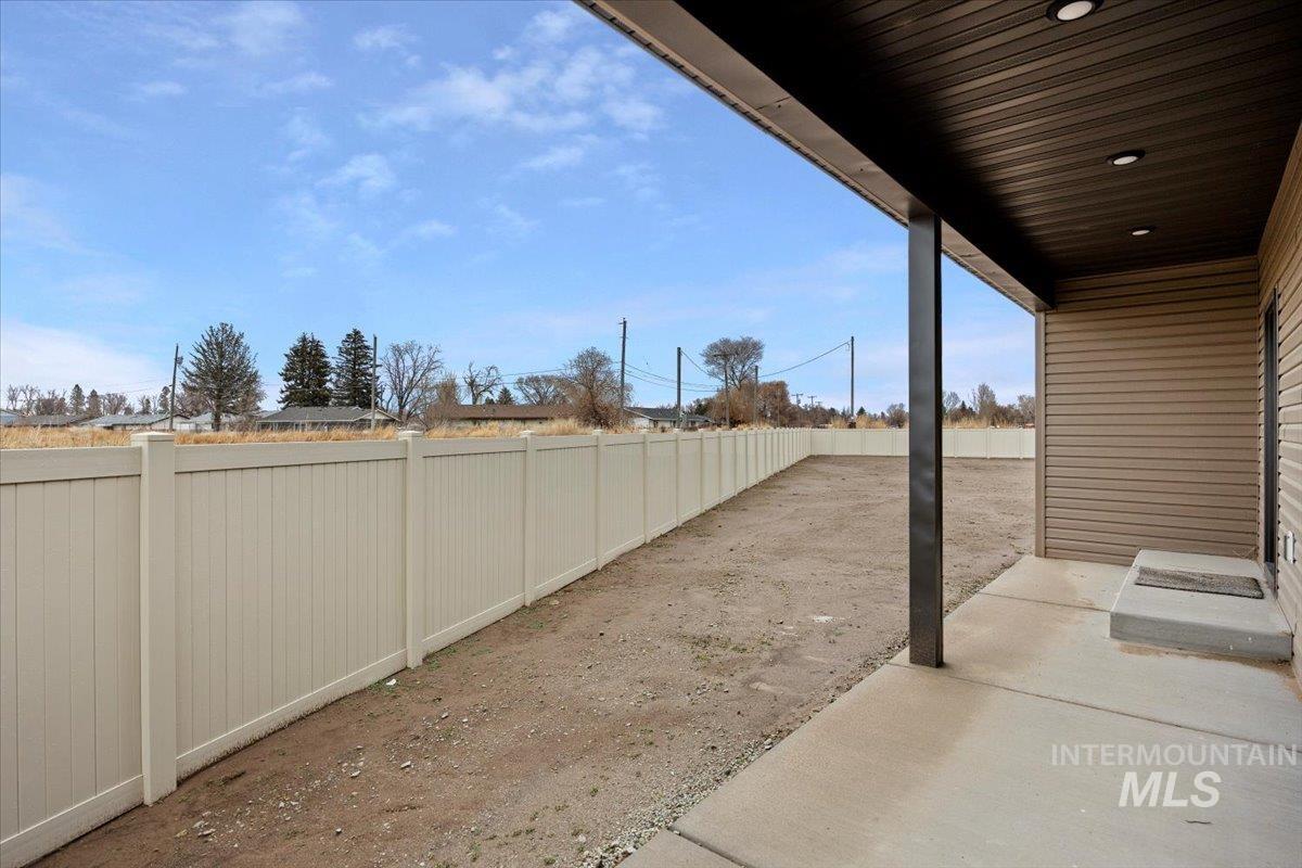 Fenced backyard with a patio area