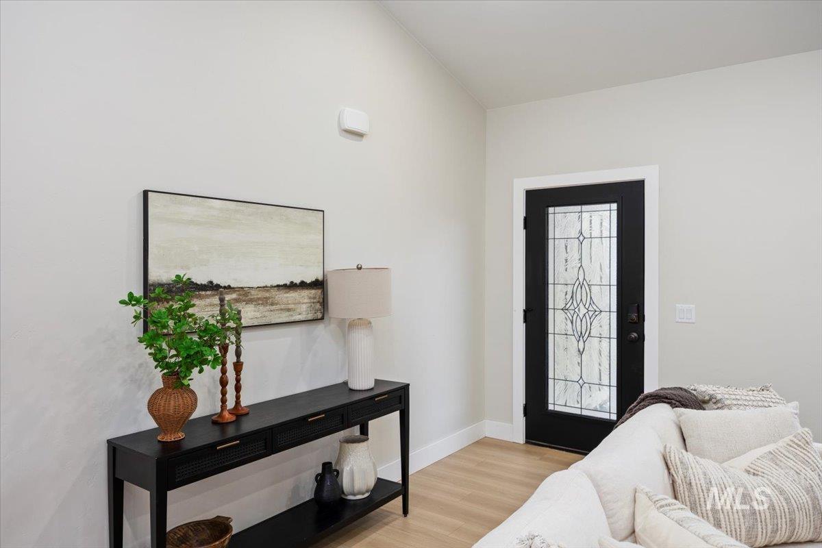 Entrance foyer with light wood-style floors and baseboards
