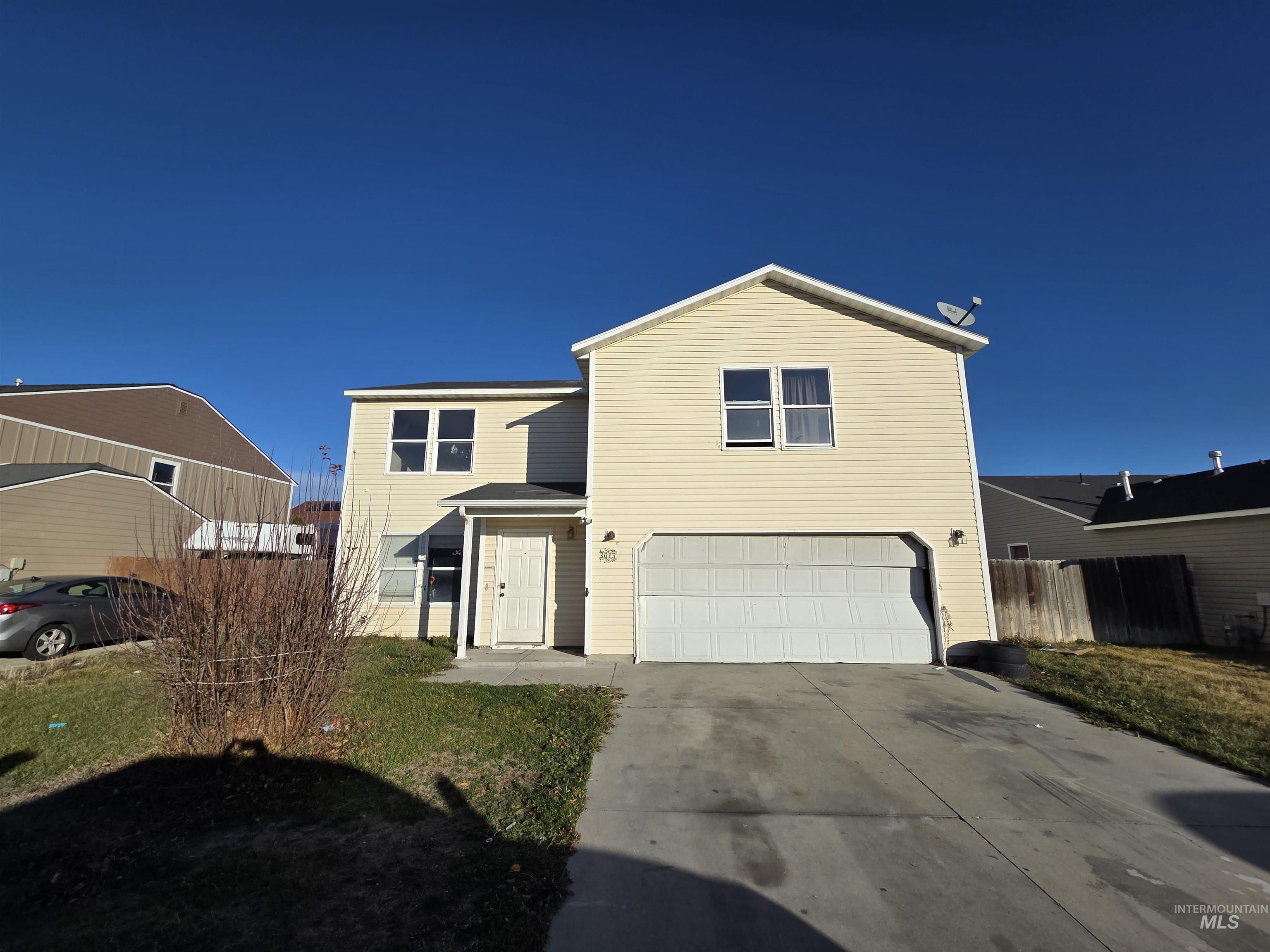 Traditional home with concrete driveway and a garage