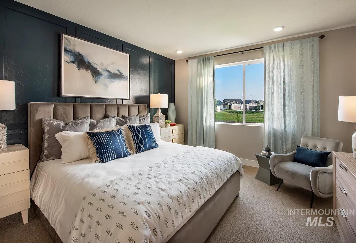 Bedroom featuring carpet, an accent wall, and recessed lighting