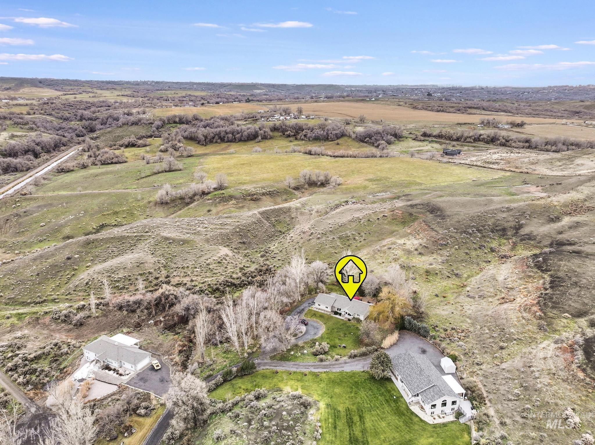 Aerial view of property and surrounding area featuring rural landscape