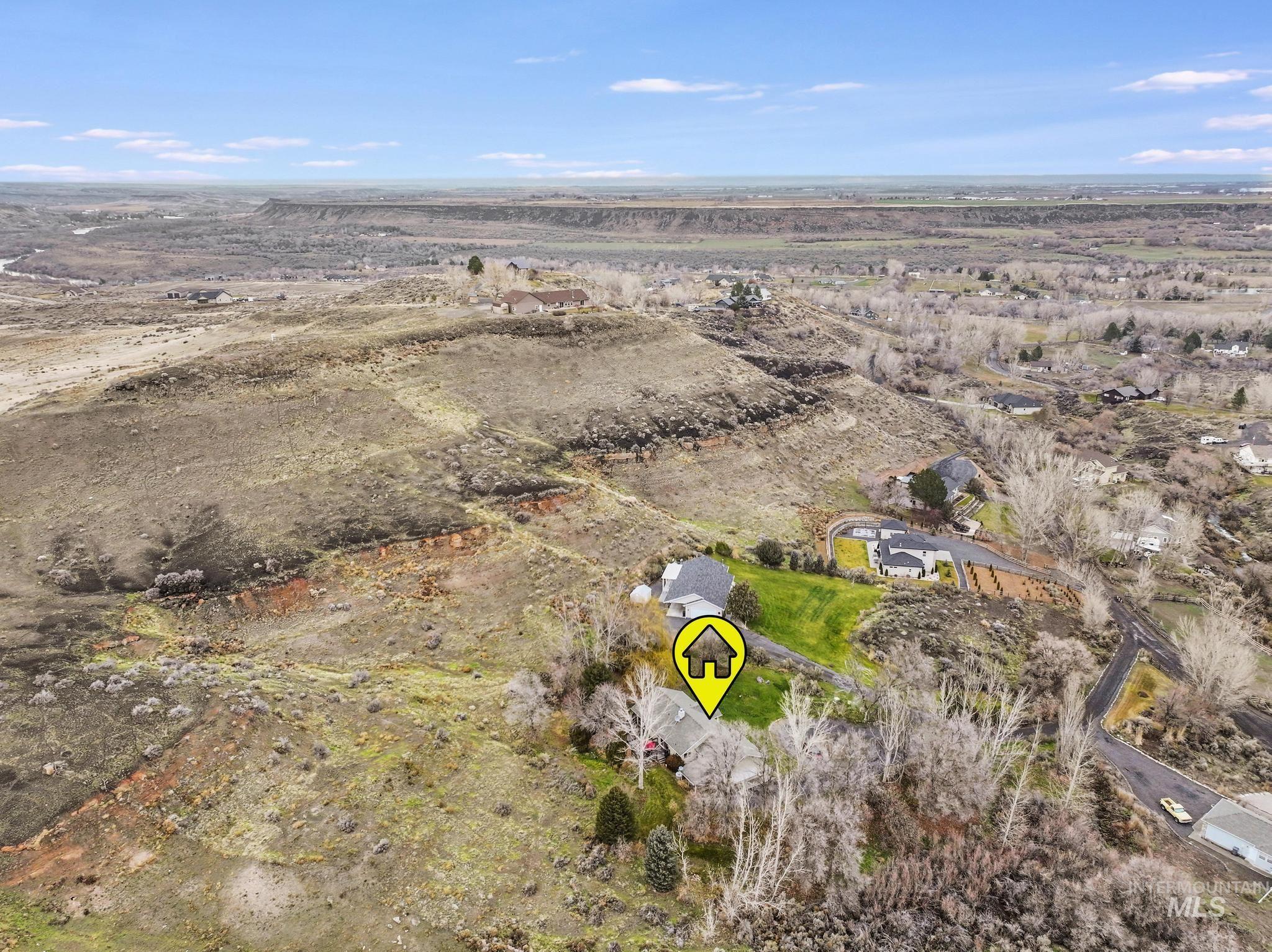 Aerial view of property and surrounding area featuring rural landscape