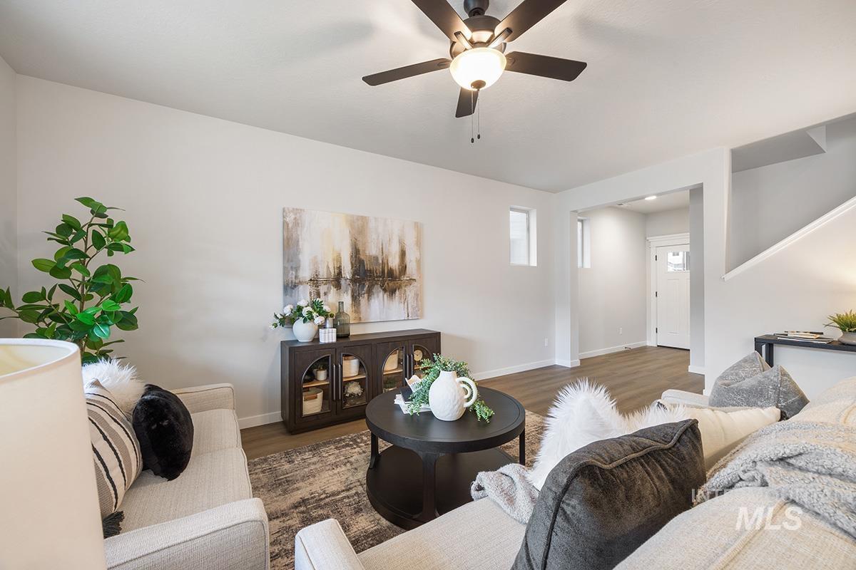 Living area featuring a ceiling fan and wood finished floors