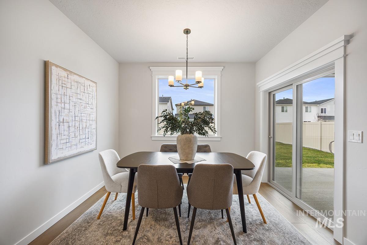 Dining area featuring wood finished floors and a chandelier
