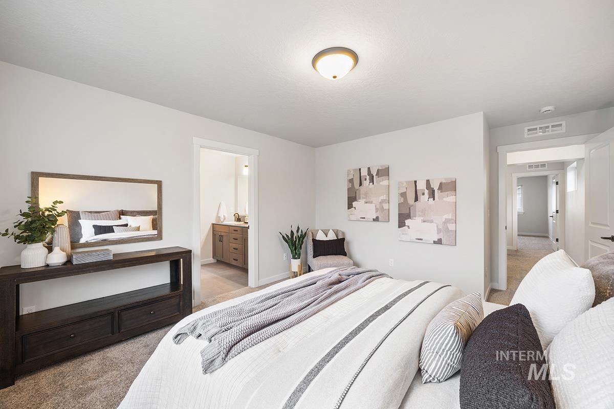 Bedroom with carpet flooring and ensuite bath