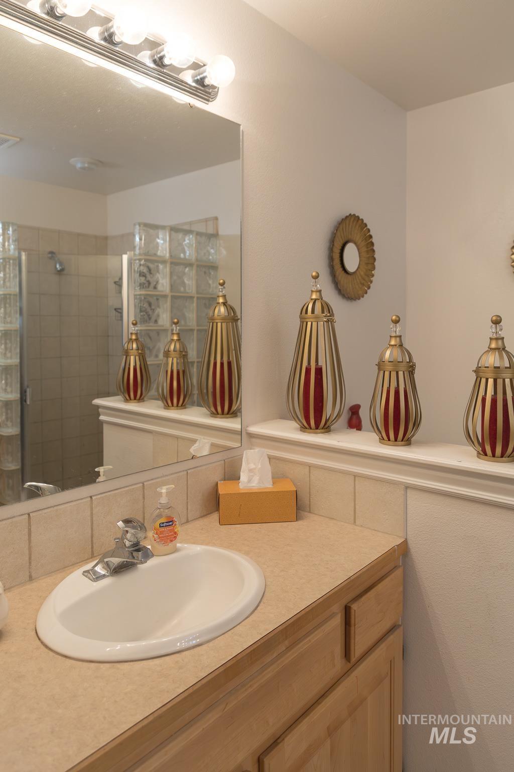 Full bath featuring vanity and a tile shower