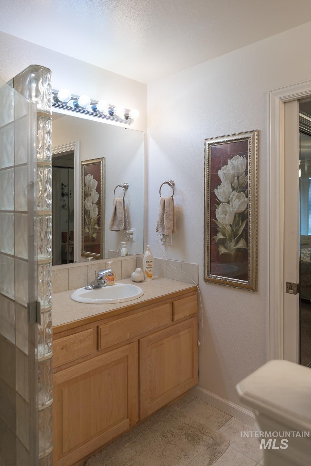 Bathroom featuring vanity and a shower stall