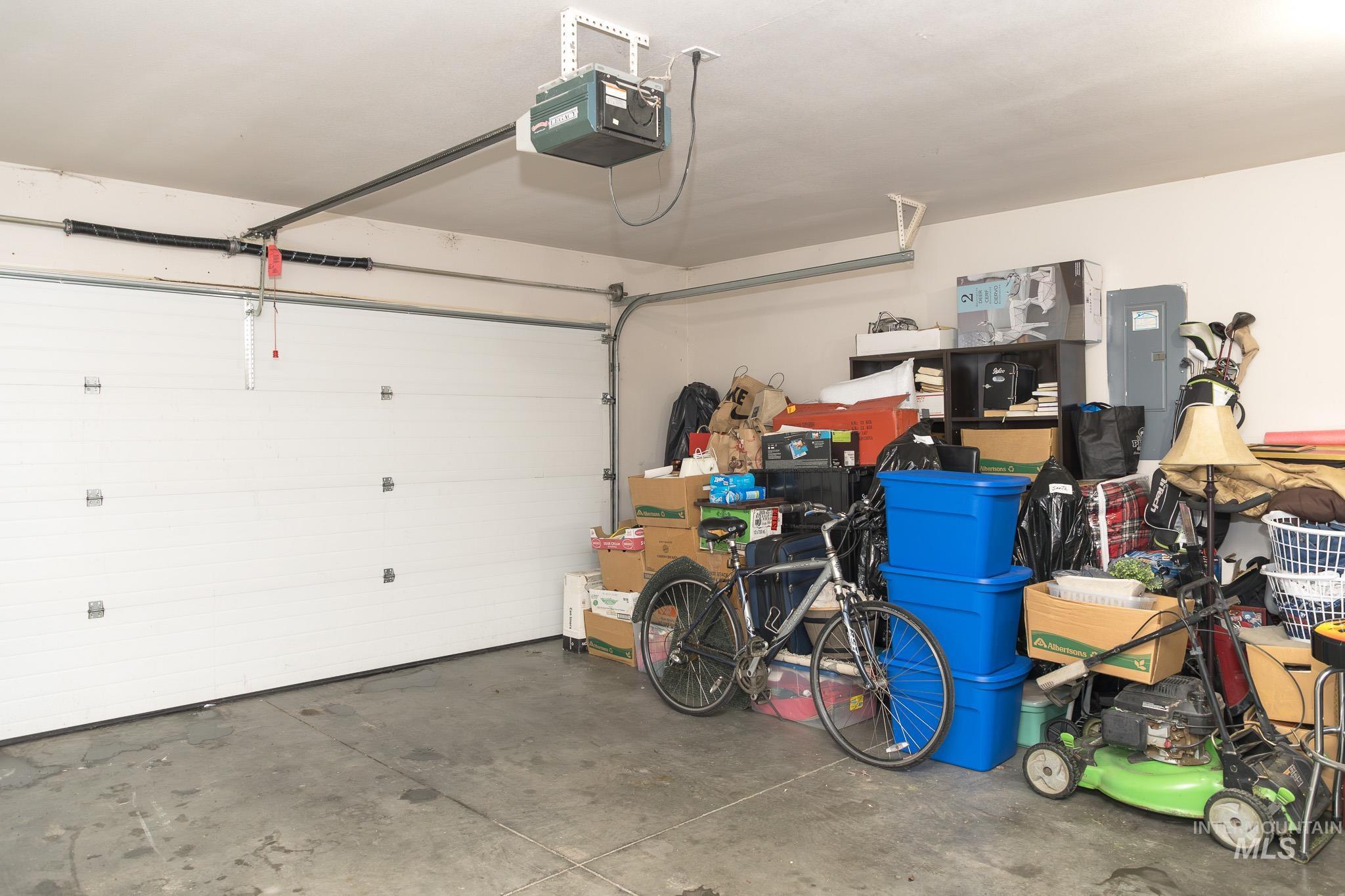 Garage with electric panel and a garage door opener