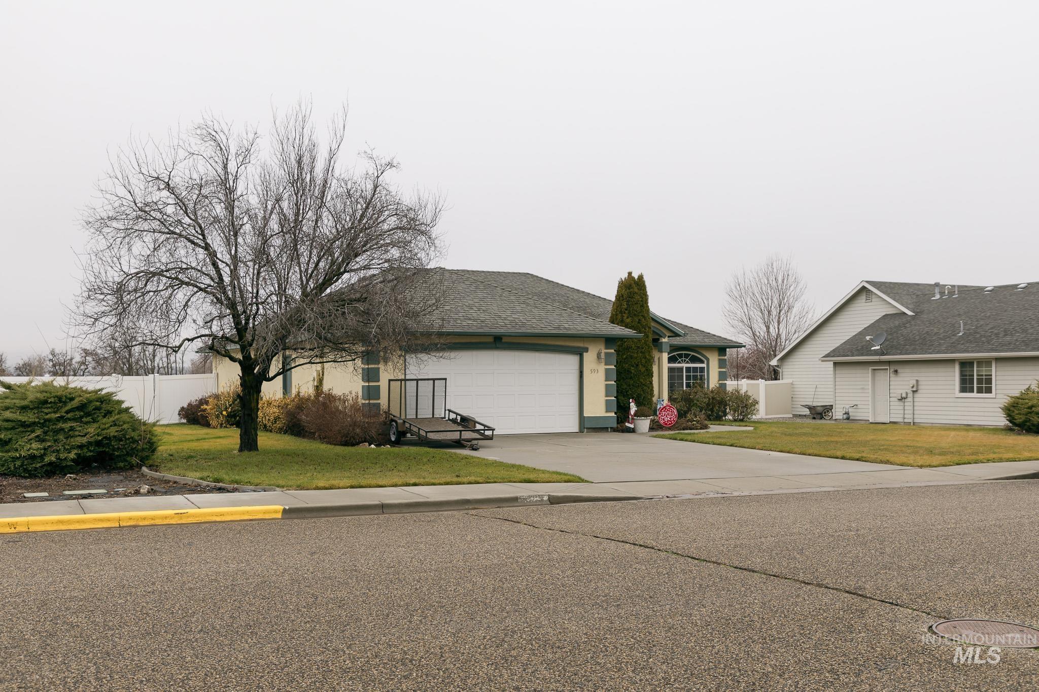 View of front of house featuring concrete driveway, a garage, and a shingled roof