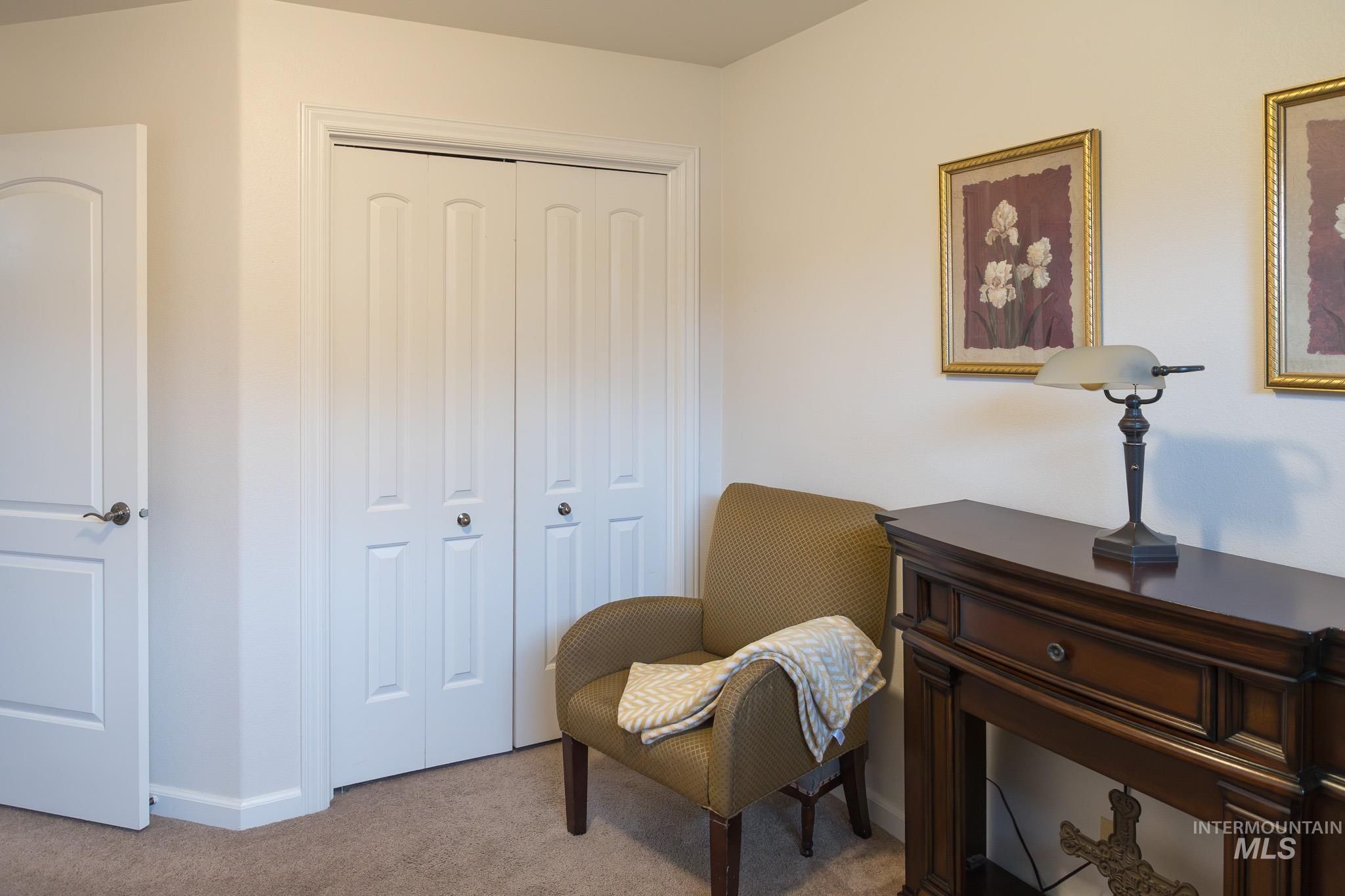 Sitting room with carpet and baseboards
