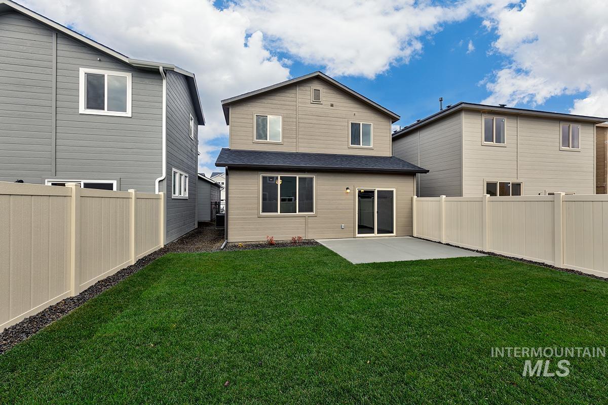 Back of house with a patio, a fenced backyard, and a shingled roof