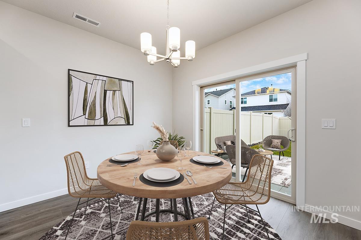 Dining area featuring a chandelier and wood finished floors