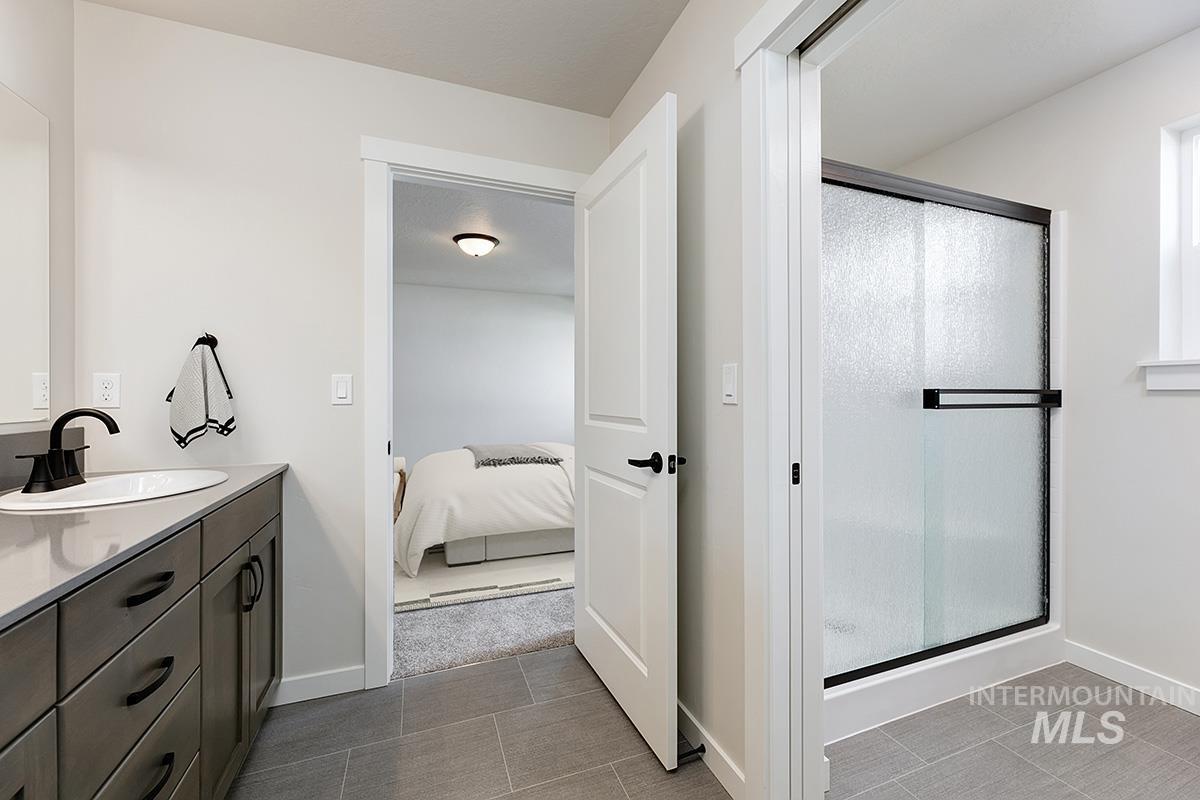 Bathroom with vanity, a shower stall, and ensuite bath