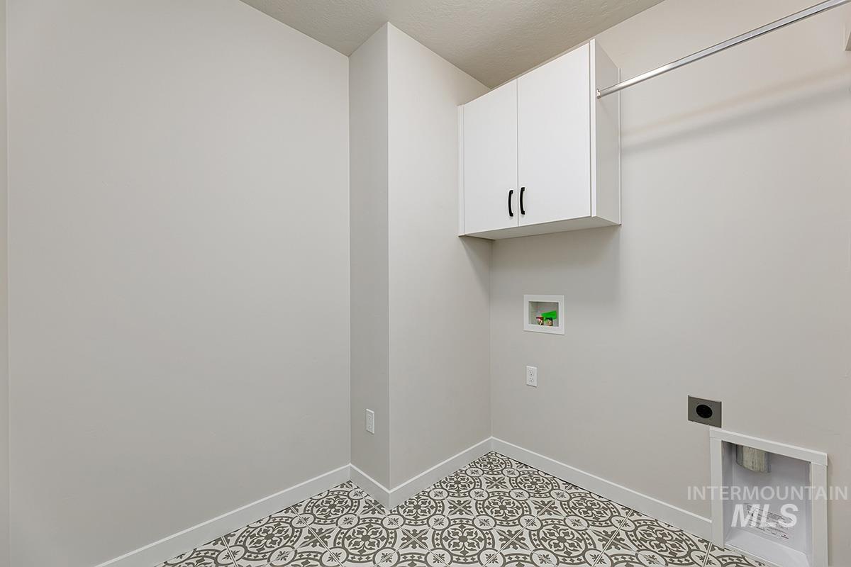 Laundry room with hookup for a washing machine, hookup for an electric dryer, and cabinet space
