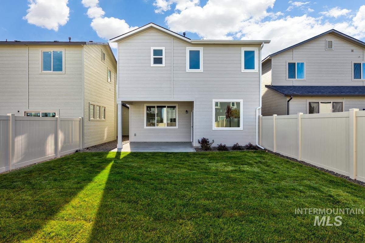 Back of house featuring a fenced backyard and a patio area