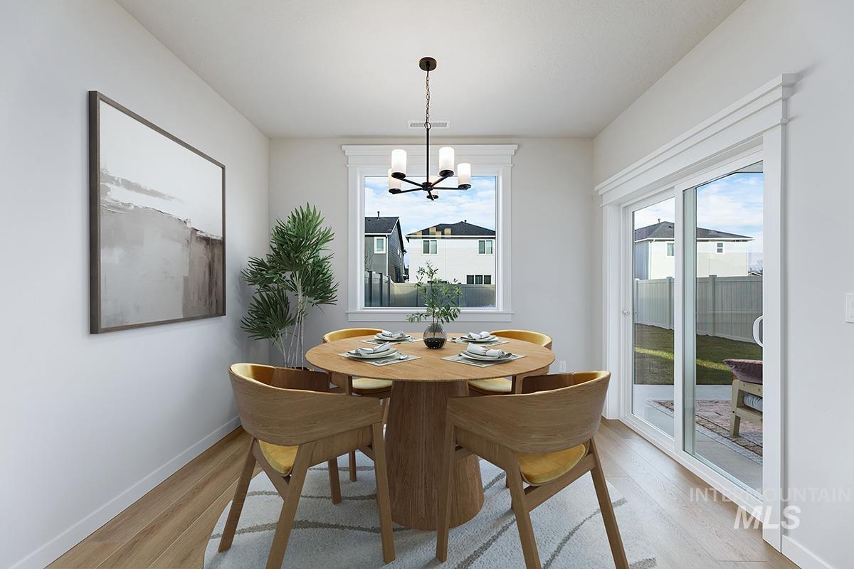 Dining area with a chandelier and light wood-type flooring