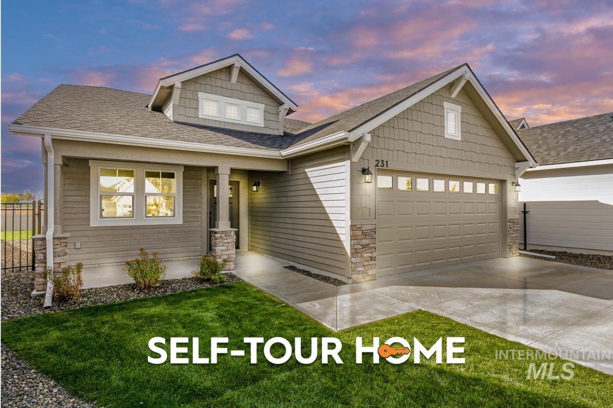 Craftsman-style home with stone siding, a shingled roof, driveway, and a garage