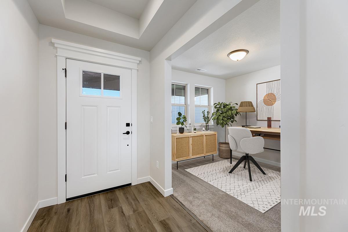 Foyer with baseboards and dark wood-style flooring