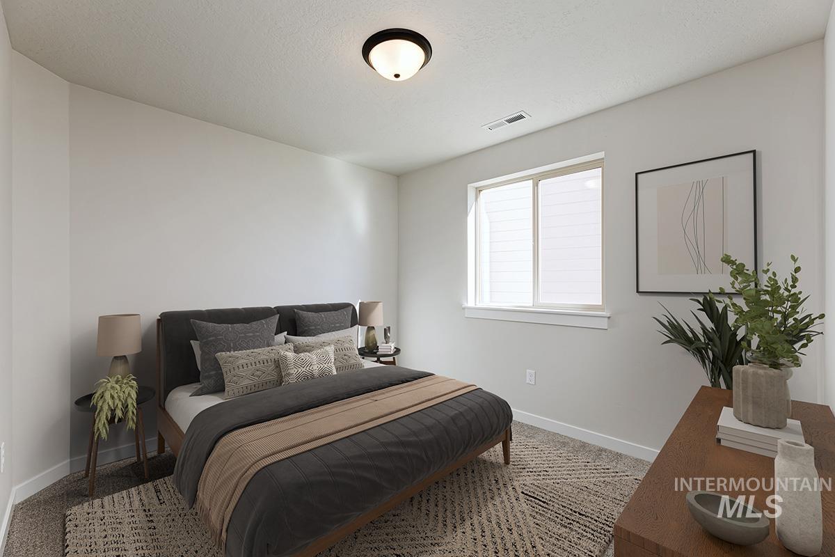 Bedroom with baseboards and a textured ceiling