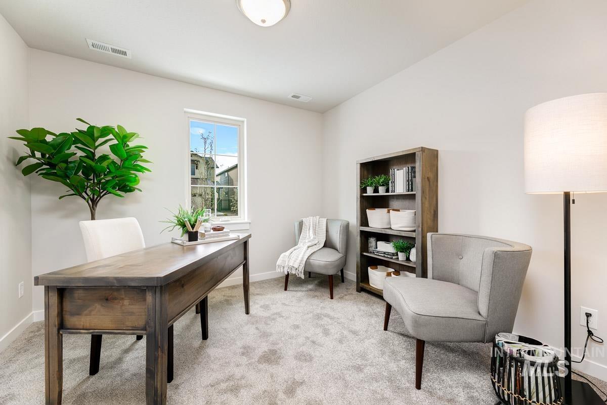 Office area with light colored carpet and baseboards