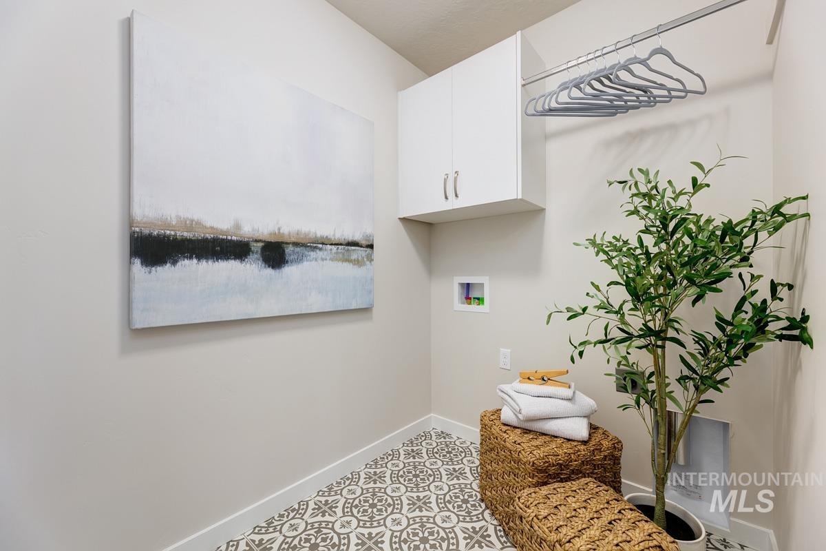 Laundry area featuring hookup for a washing machine and cabinet space