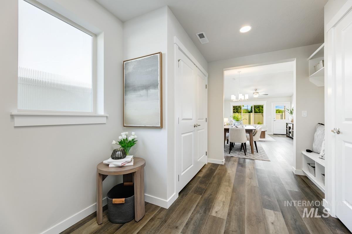 Hallway with dark wood-style flooring and recessed lighting