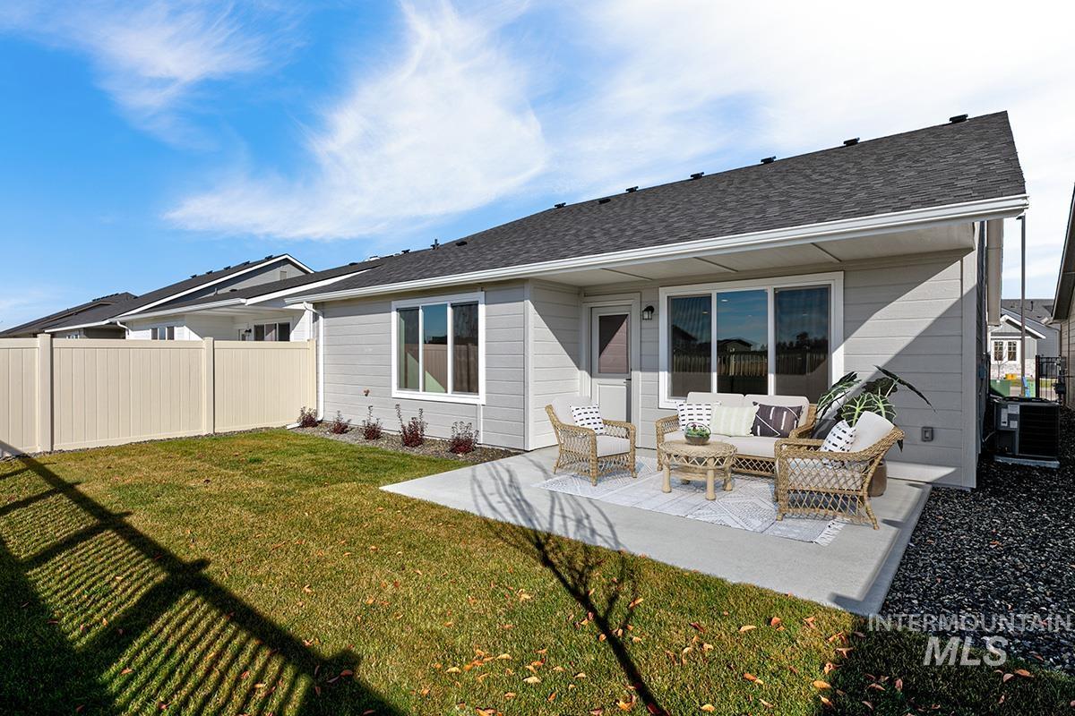 Rear view of property with outdoor lounge area, a patio area, and roof with shingles