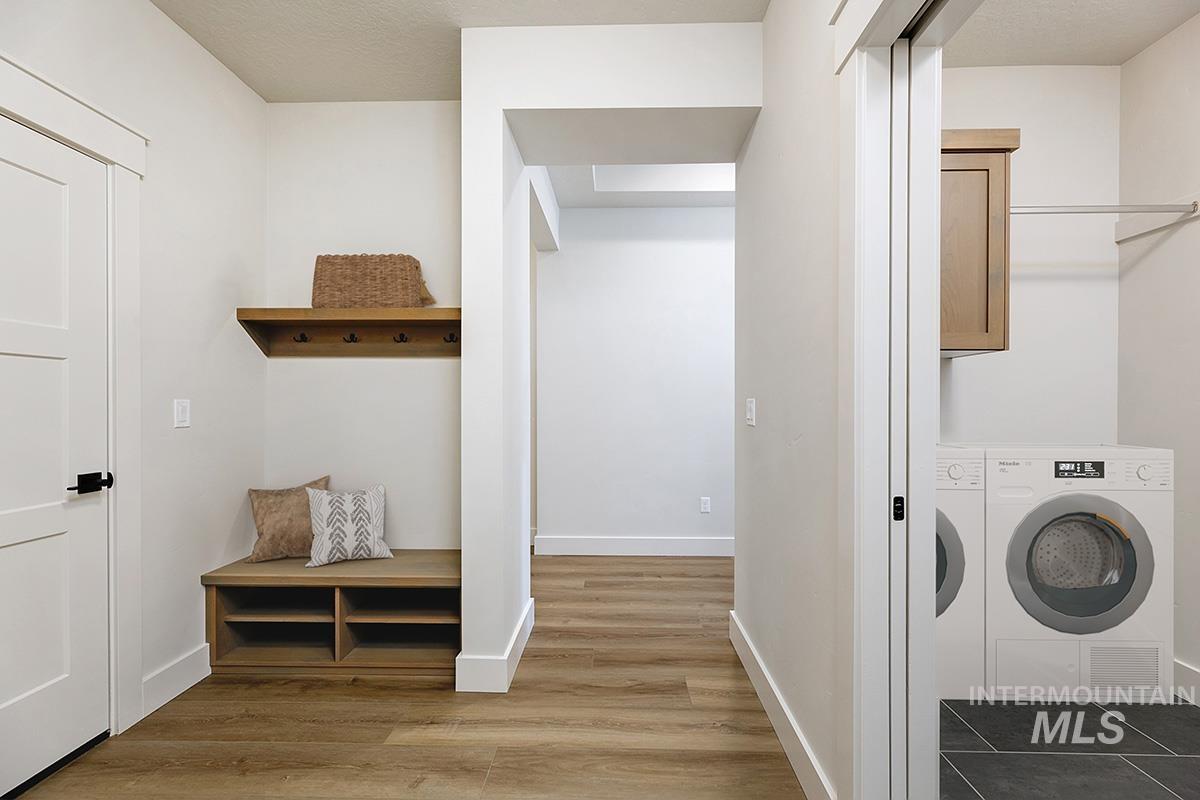 Washroom with cabinet space and wood finished floors