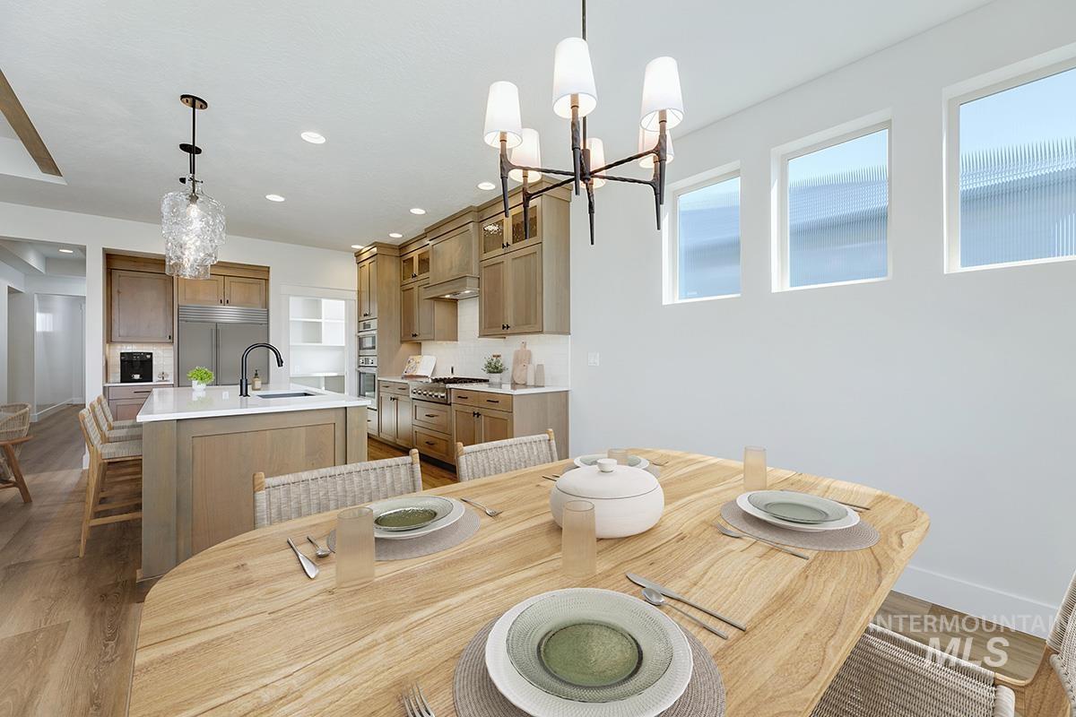 Dining space featuring a chandelier, light wood-style floors, and recessed lighting