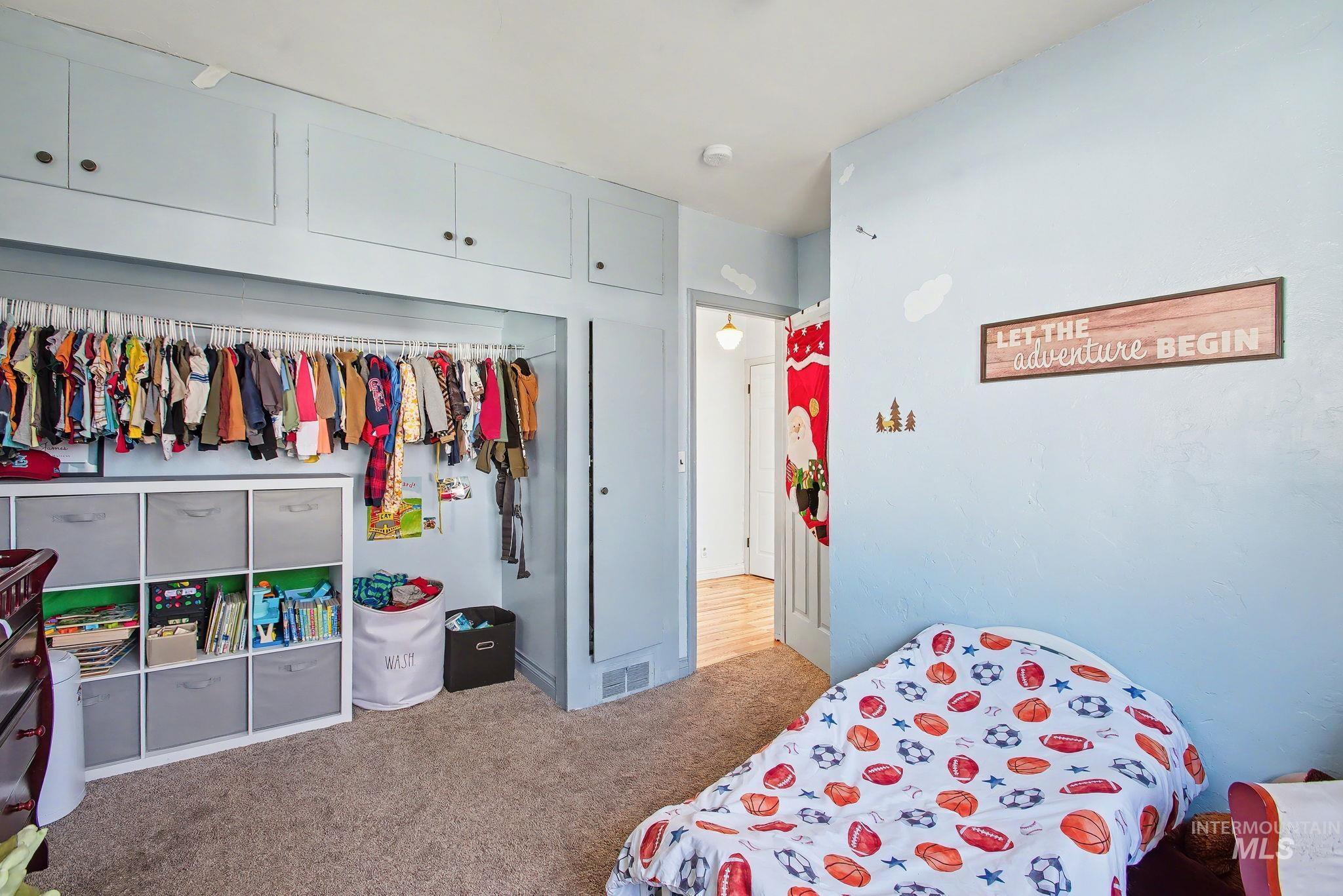 Bedroom featuring a closet and light colored carpet