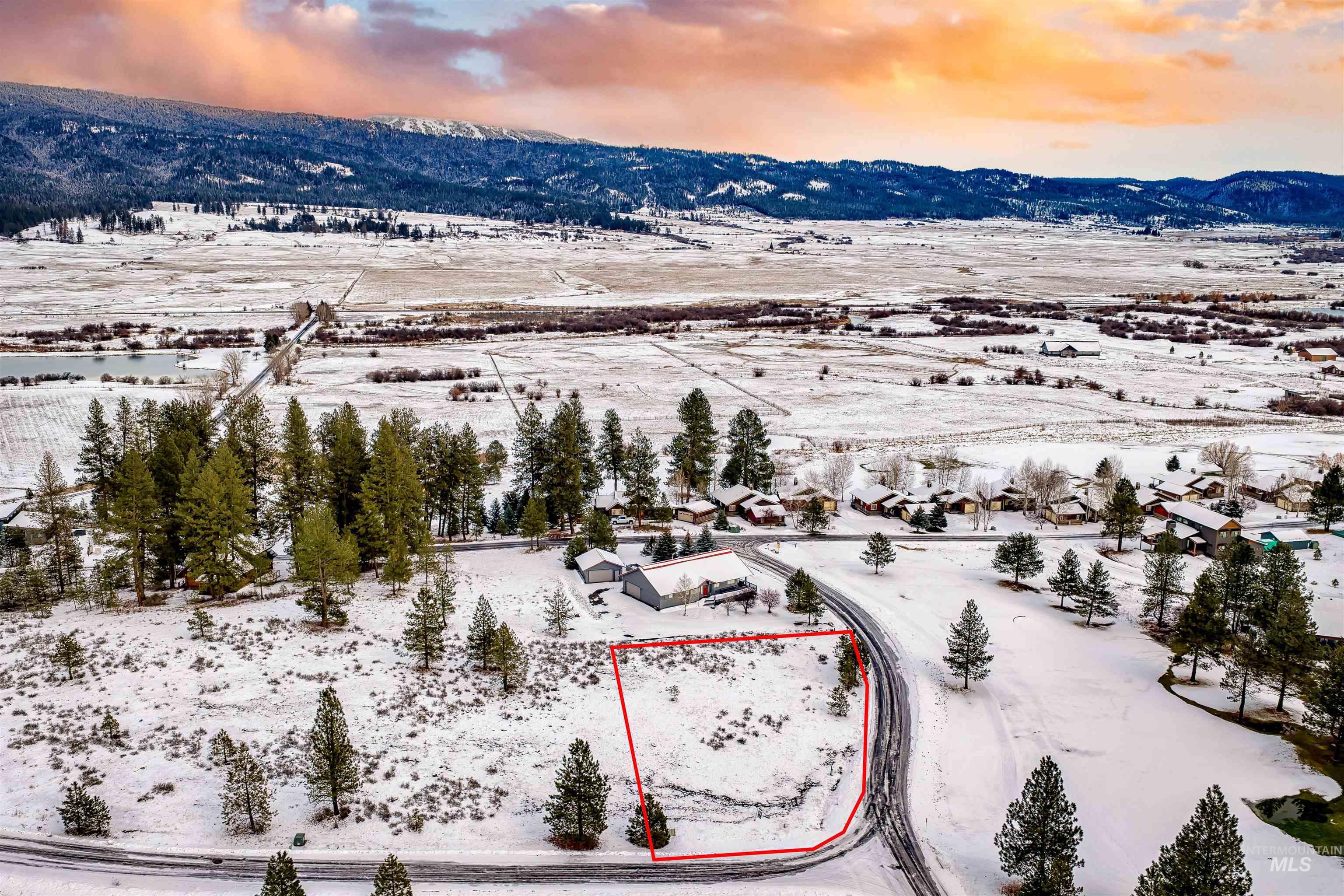 Snowy aerial view featuring property parcel outlined