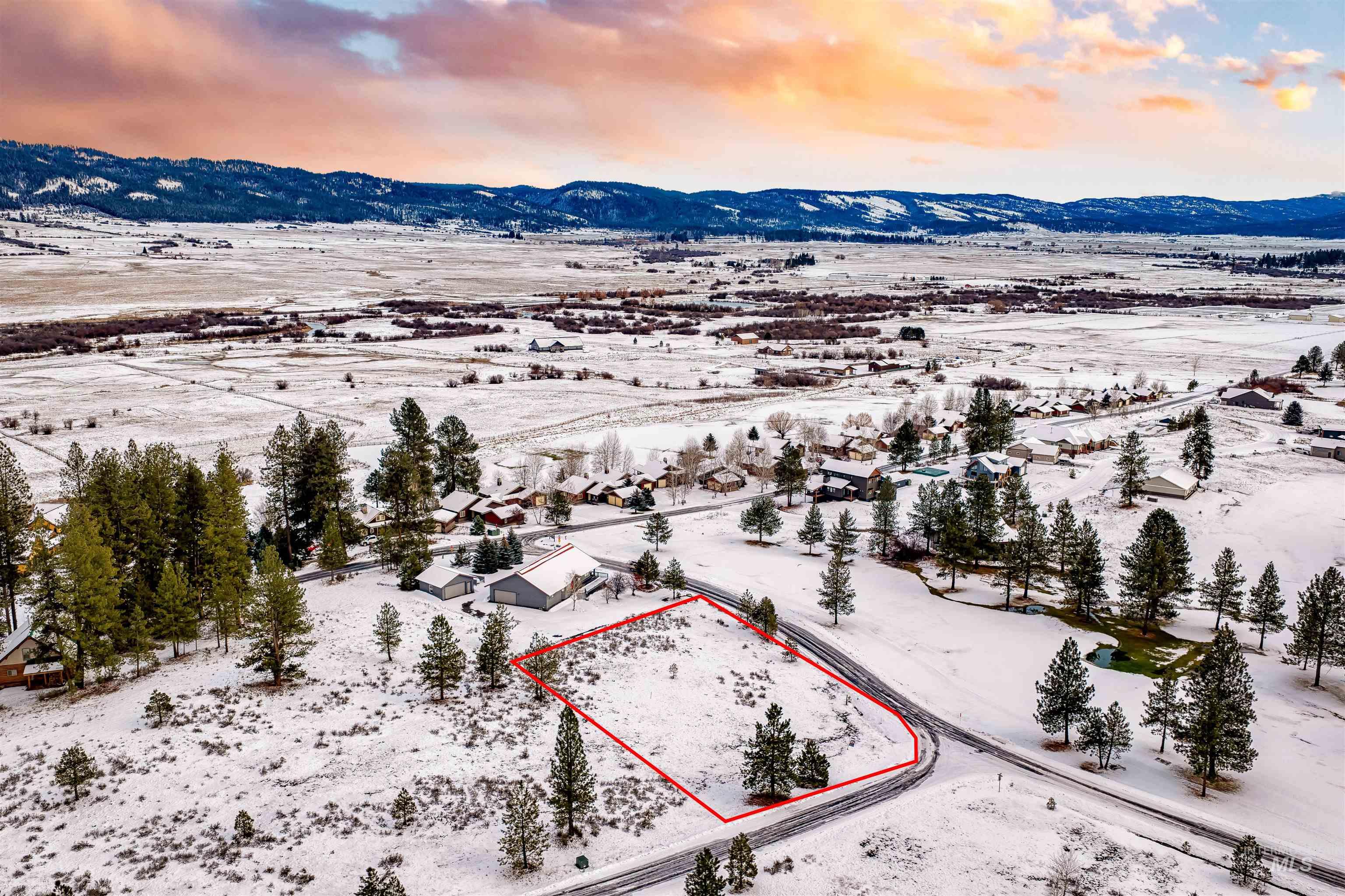 Snowy aerial view featuring property boundaries highlighted and a mountain view