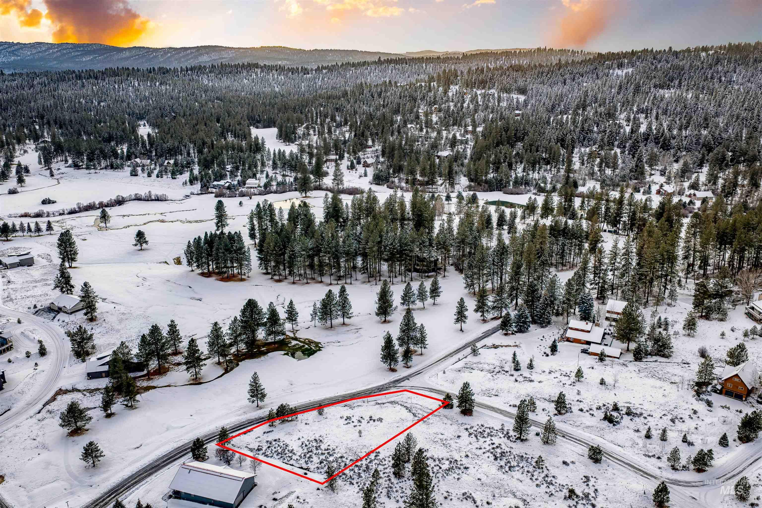 Aerial view of property and surrounding area featuring property parcel outlined and mountains