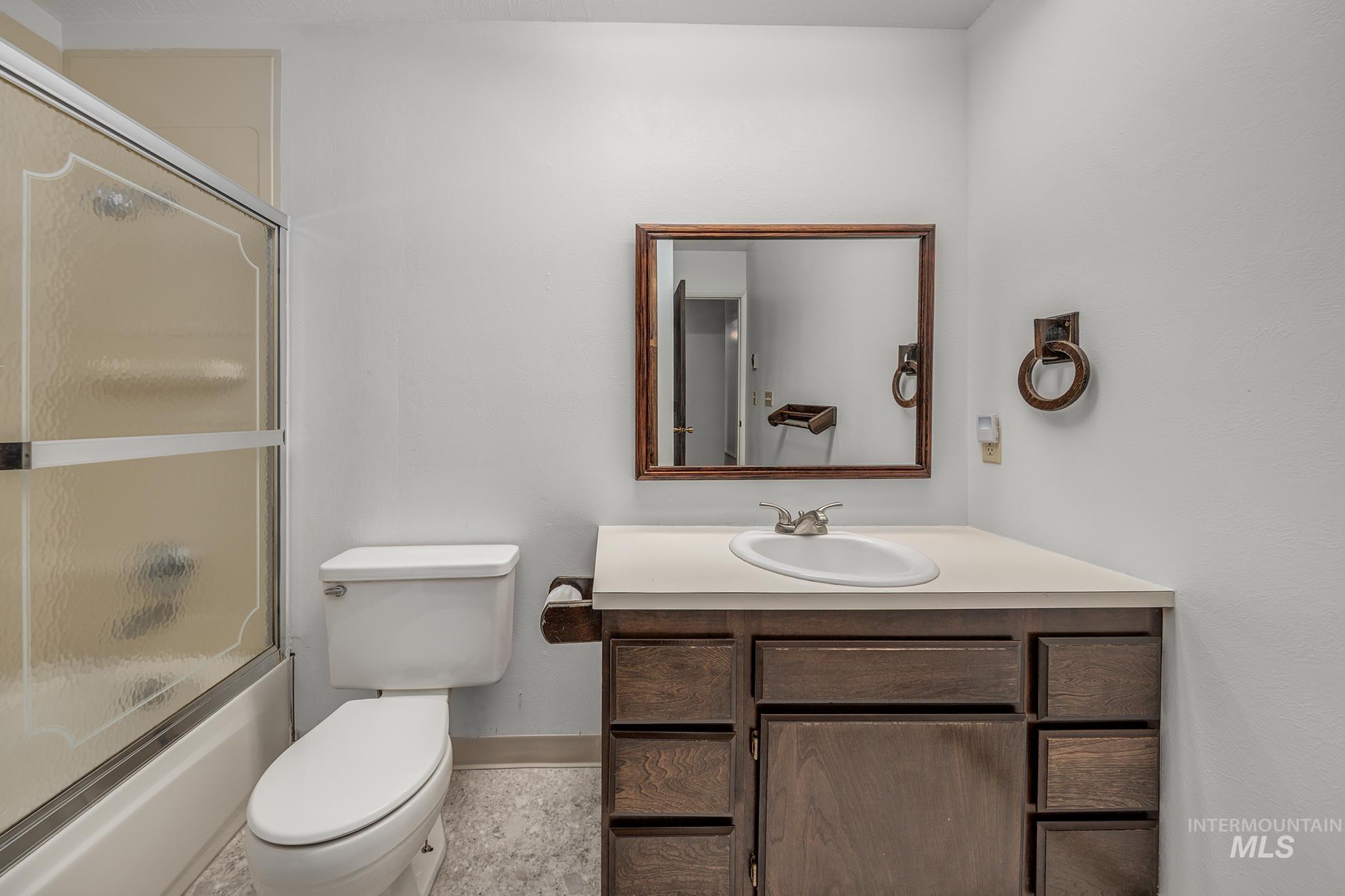 Full bathroom featuring enclosed tub / shower combo and vanity
