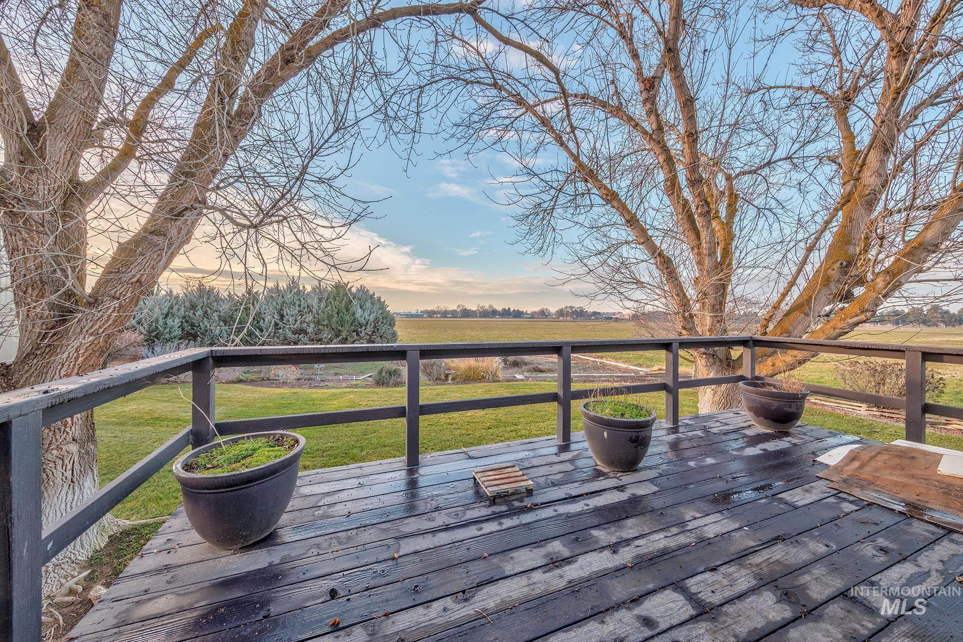 Wooden deck featuring a lawn and a view of countryside