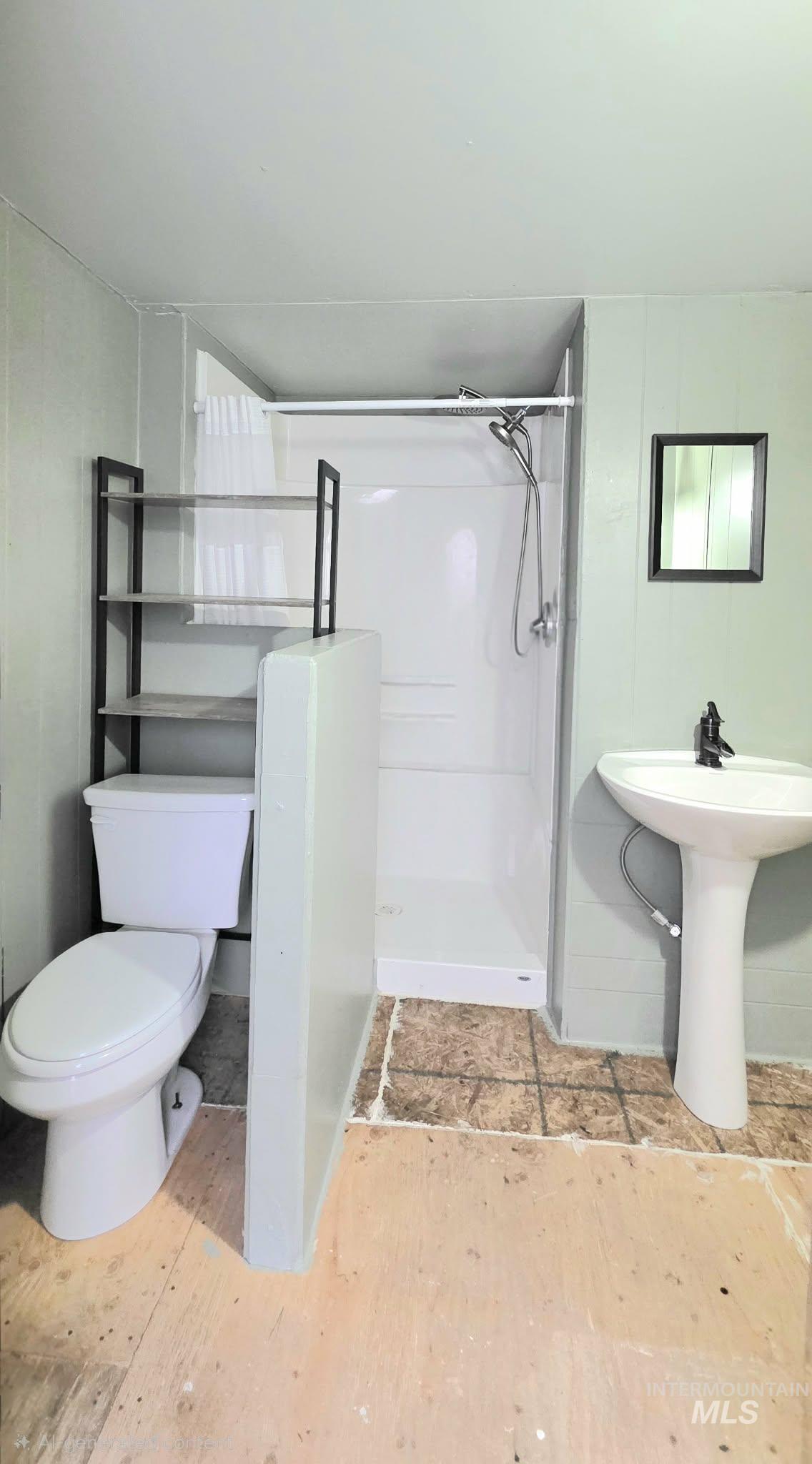 Bathroom with a shower stall and toilet
