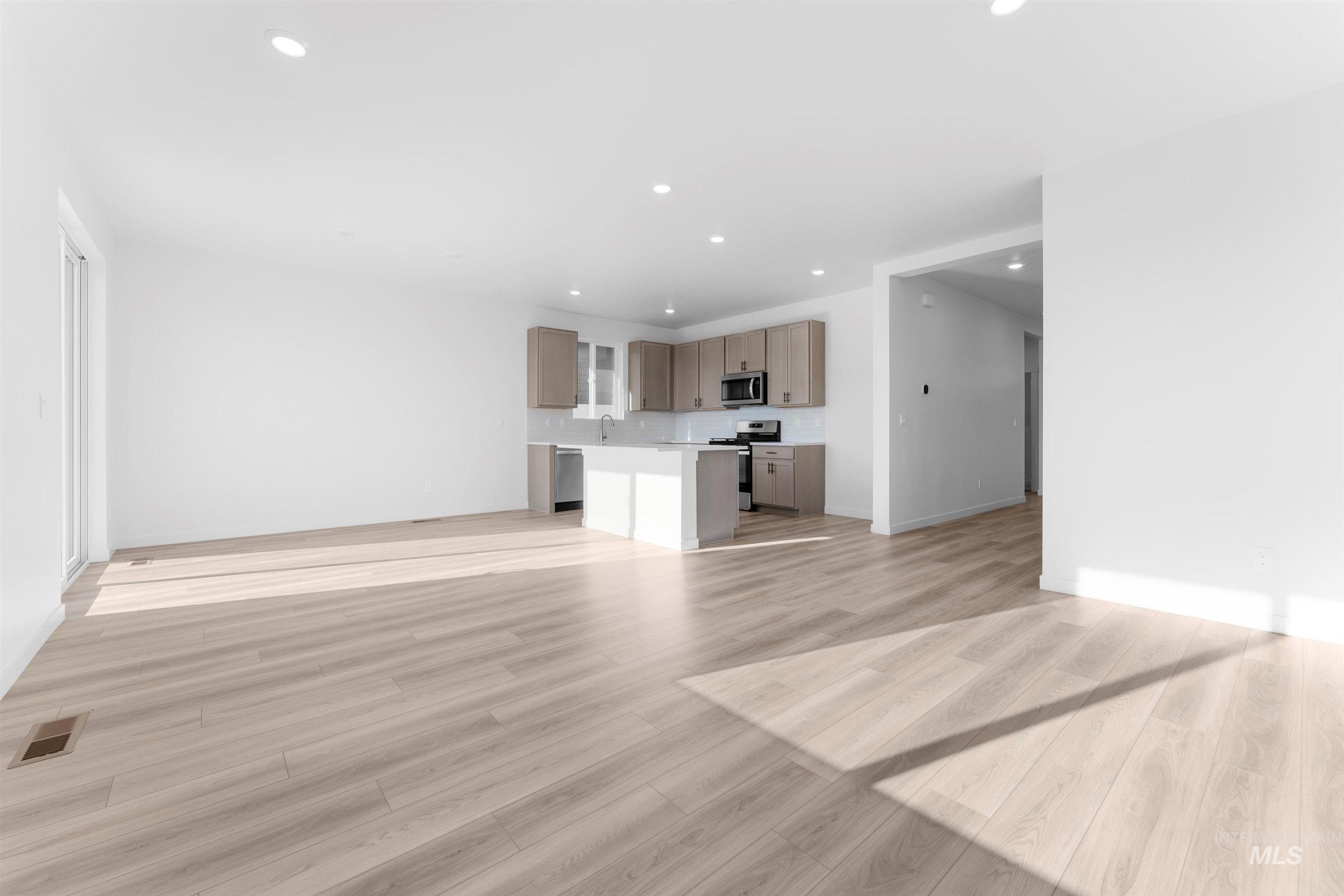 Unfurnished living room featuring recessed lighting and light wood finished floors