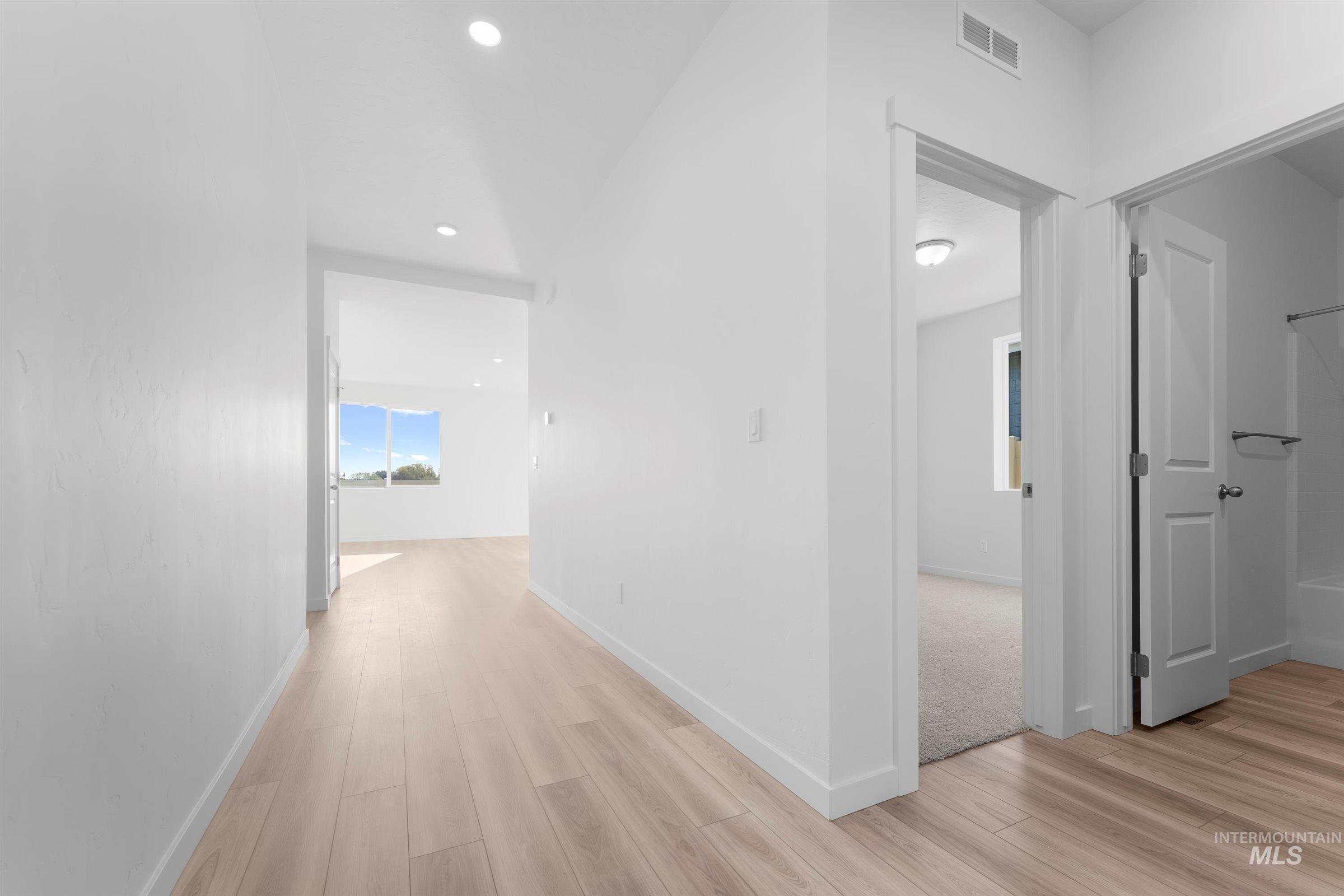 Hall featuring light wood-style floors and recessed lighting