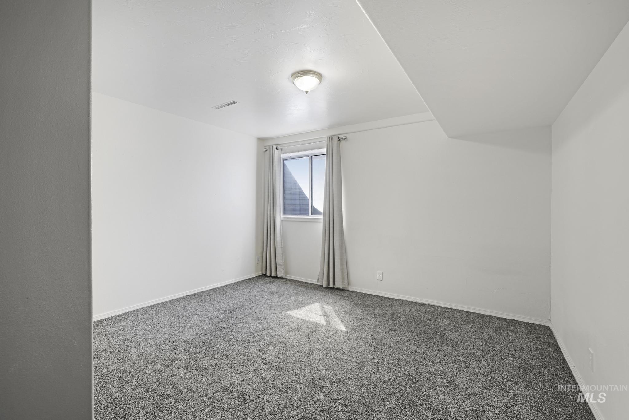Bonus room featuring carpet floors and baseboards