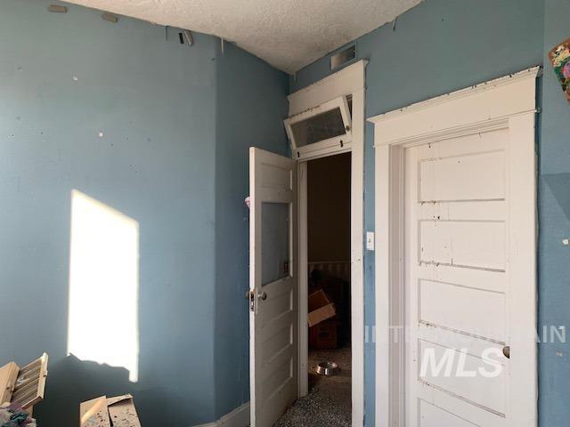 Unfurnished bedroom with a textured ceiling
