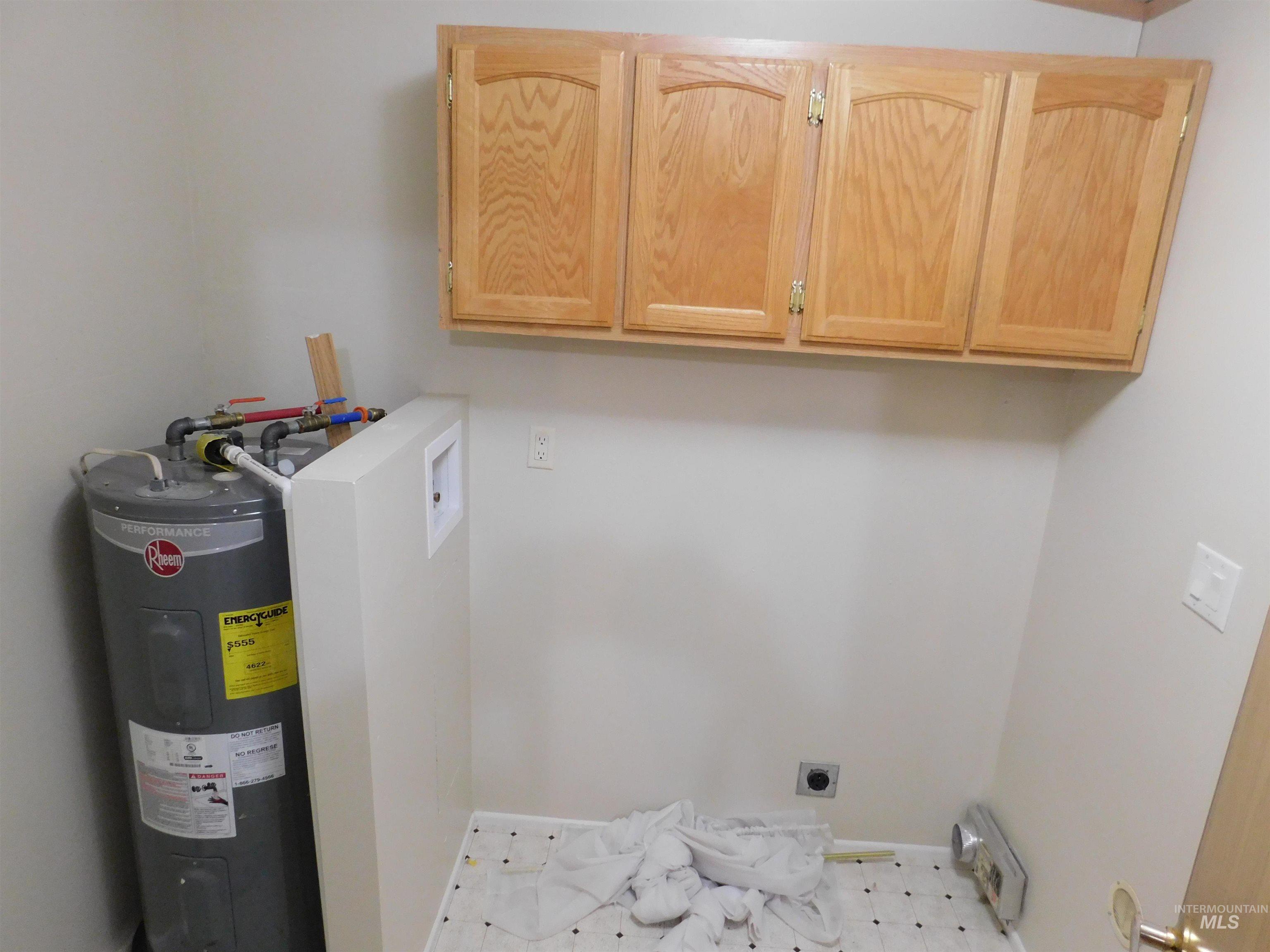 Laundry room featuring water heater, cabinet space, hookup for an electric dryer, washer hookup, and light flooring