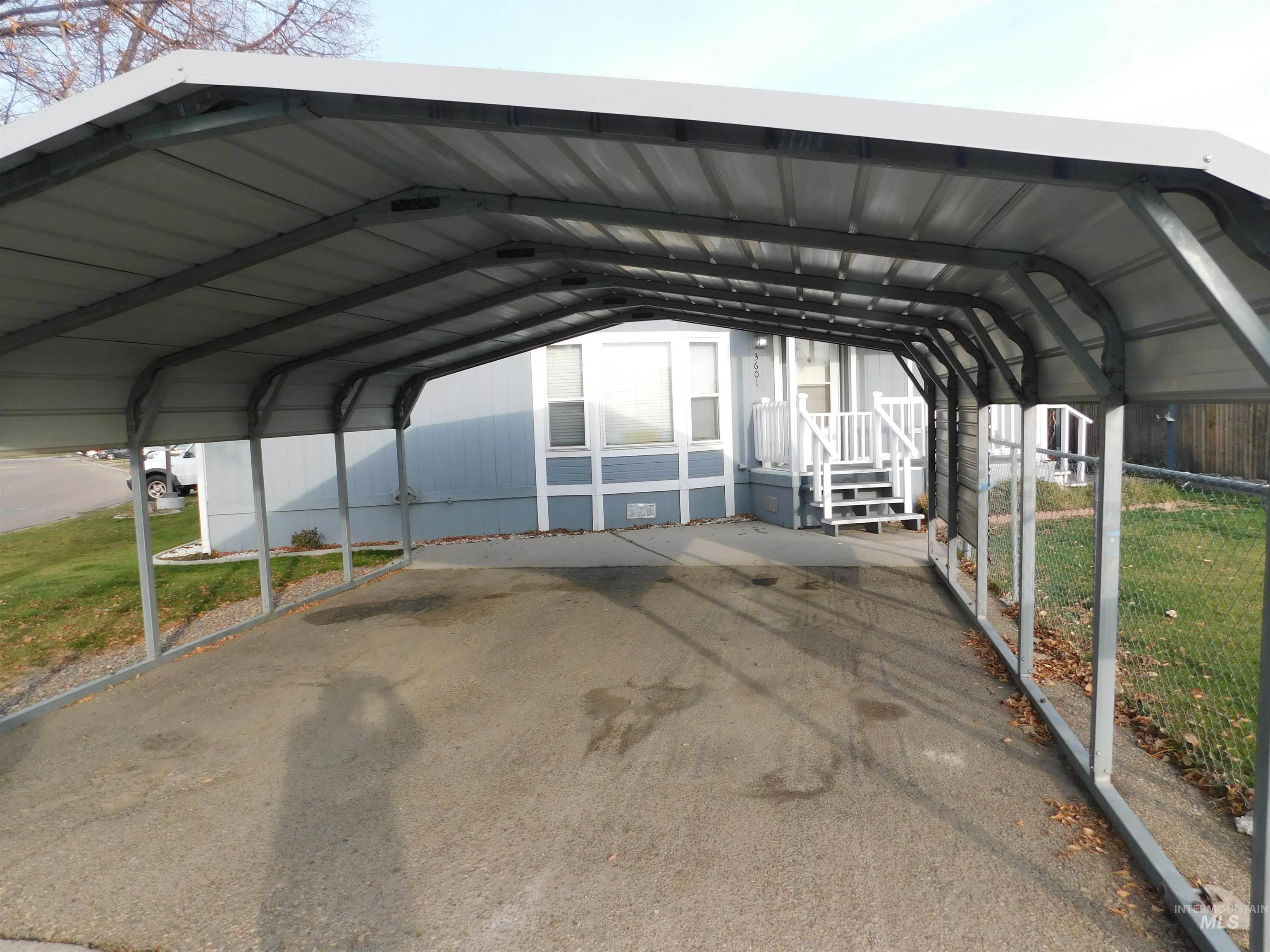 View of parking with a detached carport