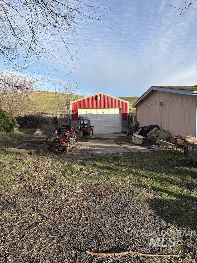 View of yard with an outbuilding and a garage