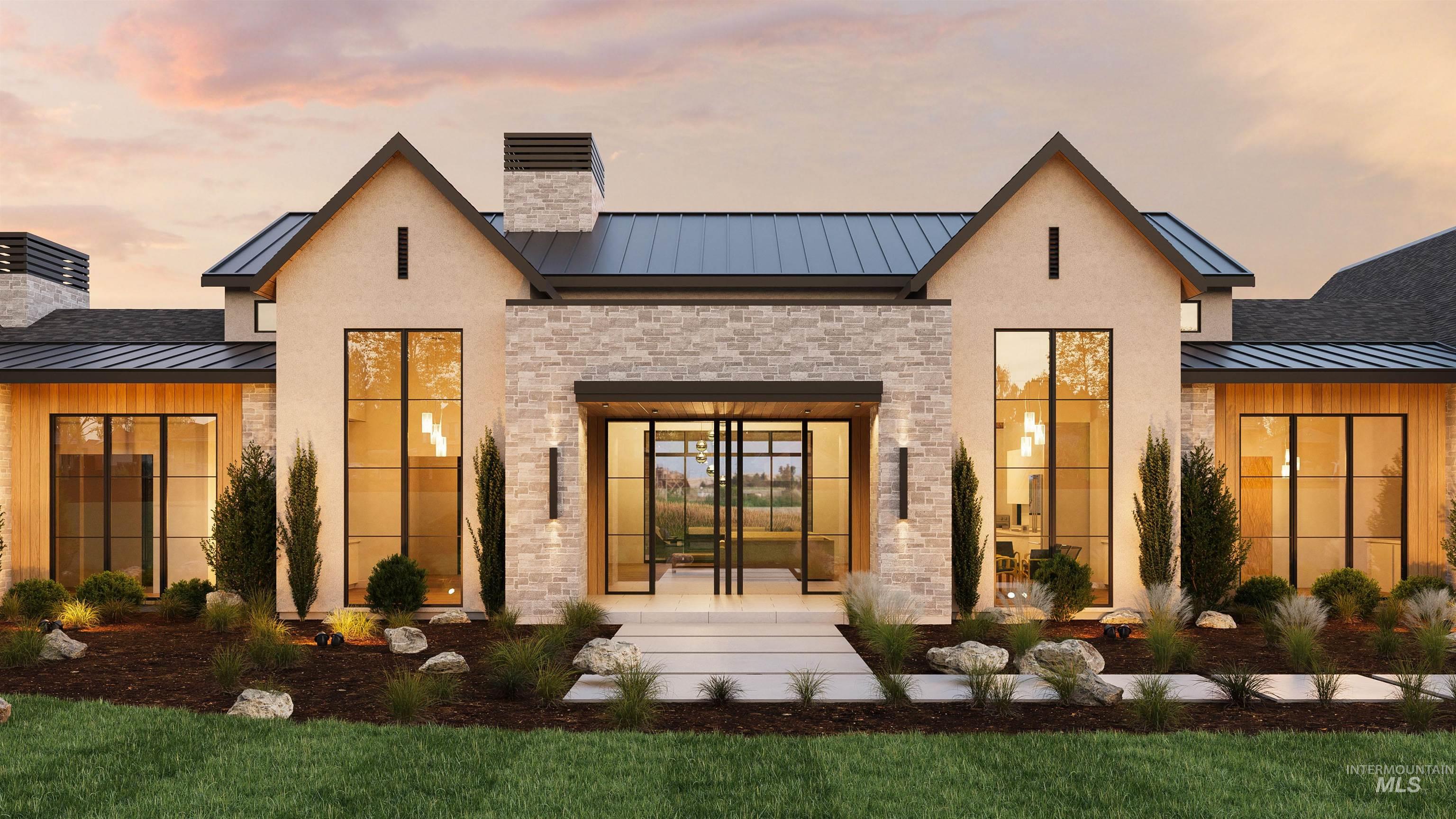 Exterior entry at dusk featuring a chimney, a standing seam roof, and a metal roof