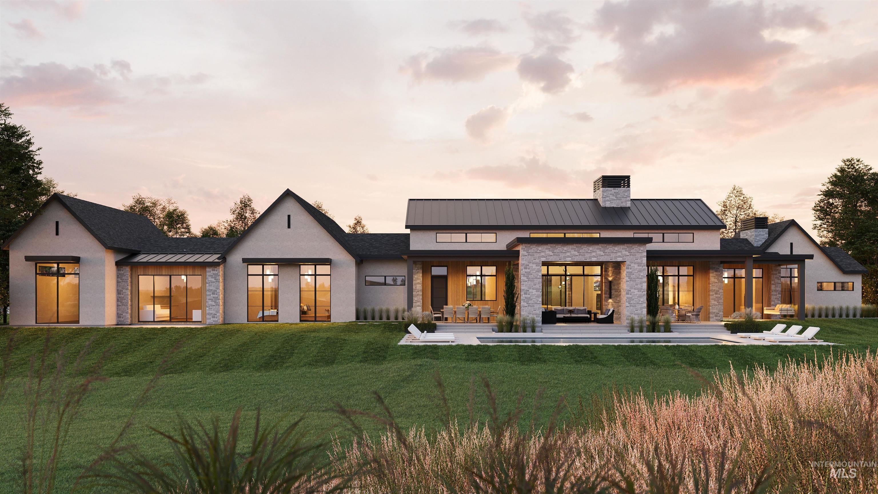 Rear view of house featuring a standing seam roof, a patio, a metal roof, and a chimney