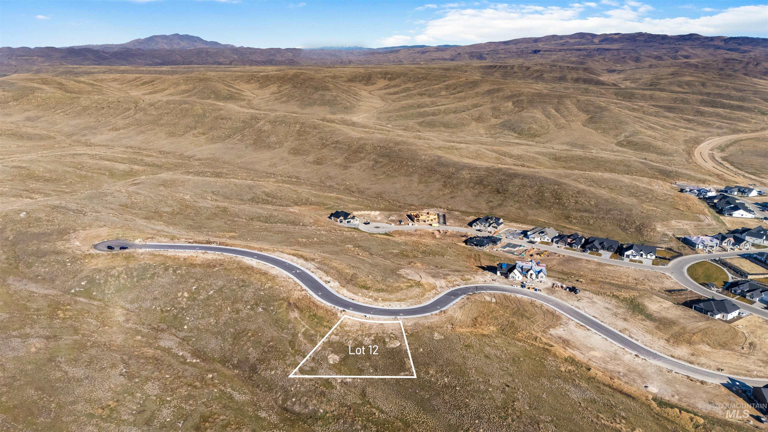 Aerial view of property's location with a mountainous background and rural landscape