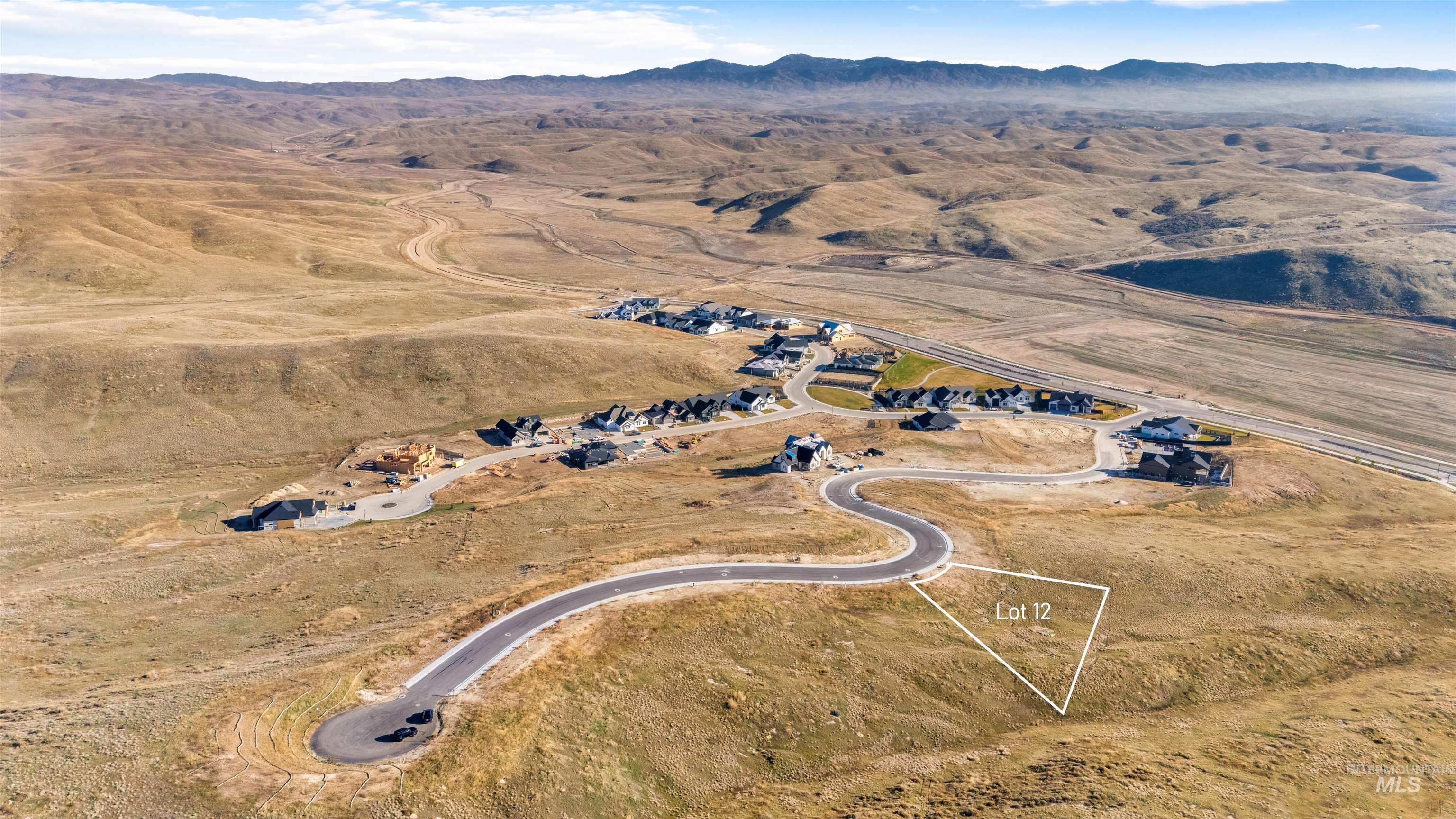 Aerial view of property and surrounding area with a mountain backdrop and rural landscape