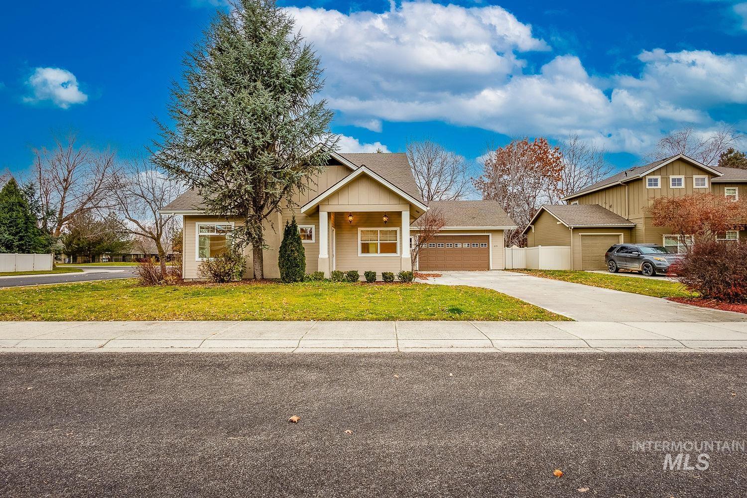 View of front facade featuring roof with shingles and concrete driveway